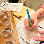 Contestant noting answers for trivia night at Orchid Cellar Meadery & Winery