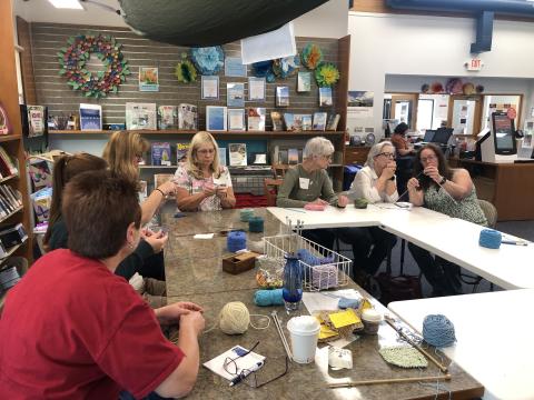 knitters working around a table