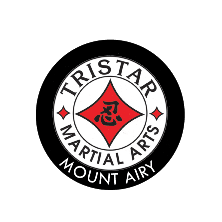 Black outlined circle with the words Tristar Martial Arts Mt. Airy around a red diamond shape