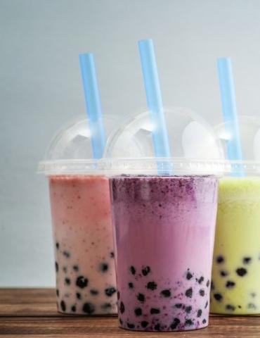 Image of three cups of bubble tea with blue straws