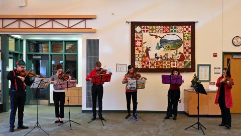 Six violinists play their instruments in Thurmont Regional Library