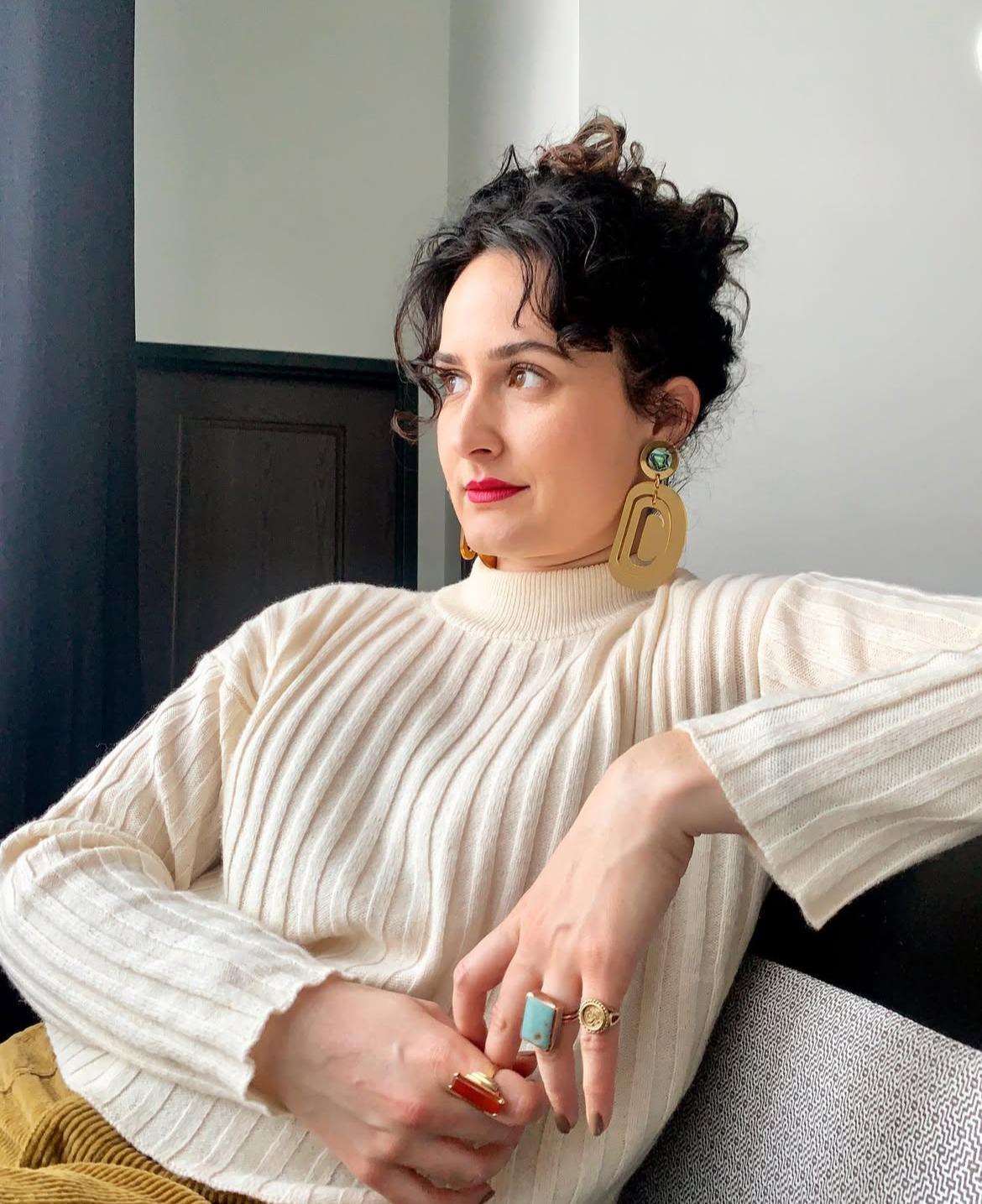 Nikoletta Gjoni wearing a white sweater